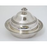 A silver plate muffin dish and cover .