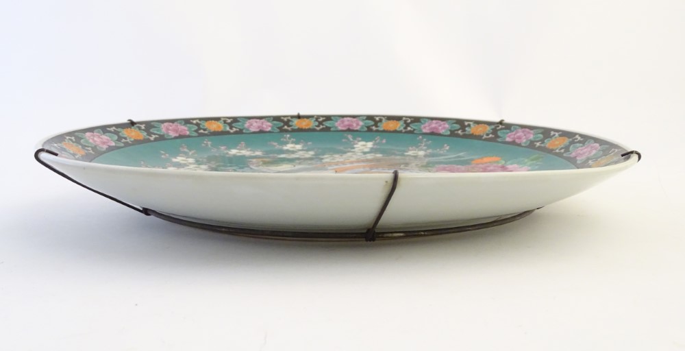 A Japanese charger depicting stylised pheasants, peonies, and cherry blossom on a green ground. - Image 7 of 9