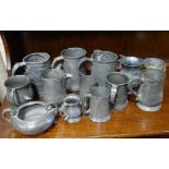 A collection of Victorian and later pewter, many marked with touch marks, coats of arms,