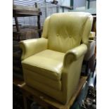 A beige coloured leathered upholstered armchair CONDITION: Please Note - we do not