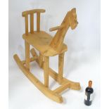 A carved wooden rocking horse CONDITION: Please Note - we do not make reference to