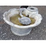 A greyed fiber glass antique style garden fountain with a Georgian dolphin and scallop shaped pool ,