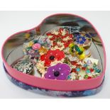 A heart shaped tin containing an assortment of bracelets CONDITION: Please Note -