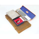 A silver plated cigarette box, together with a vanity set case, a modern pocket watch,