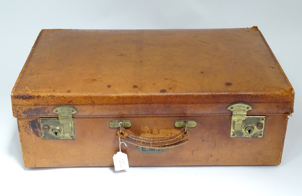 An early to mid 20thC pigskin leather suitcase with brass fitments CONDITION: Please