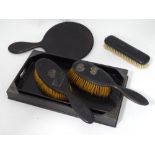 Ebony dressing table items comprising brushes,