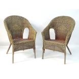 A pair of late 20thC Lloyd Loom style armchairs.