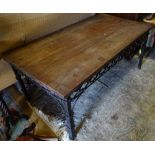 A wrought iron coffee table with a mahogany top CONDITION: Please Note - we do not