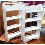A pair of white painted book shelves.