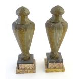 A pair of Art Deco gilded metal and marble lidded urn garnitures on square stepped bases,