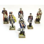 A group of six French ceramic Napoleonic military figures with various attributes and poses,