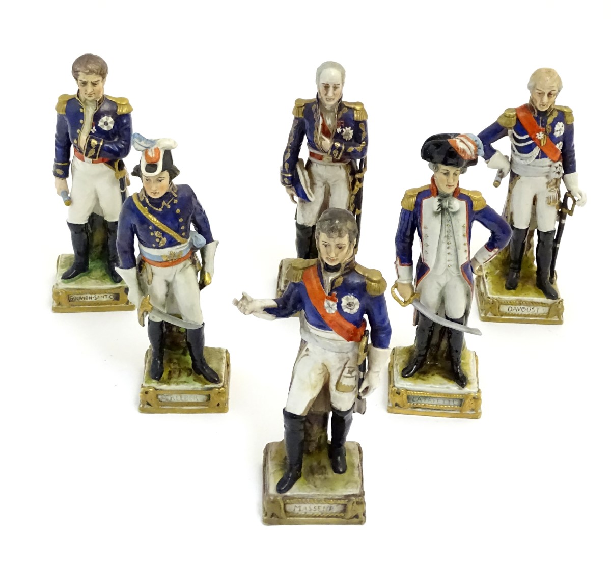 A group of six French ceramic Napoleonic military figures with various attributes and poses,