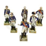 A group of six French ceramic Napoleonic military figures with various attributes and poses,