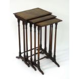 A nest of three early 19thC mahogany tables with rectangular tops above turned supports with ring