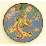 A contemporary gilt edged cloisonne dish with a bird flying amongst prunus and peonies,