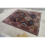 Carpet rug : a large handmade woollen Persian carpet with central dark green hexagonal roundel,