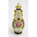 A small Crown Staffordshire lidded vase with panelled floral decoration and gilt highlights.