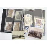 An album containing a collection of early postcards and photographs.