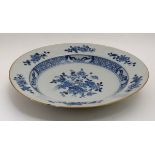 A blue and white Chinese ceramic plate. Decorated with flora in central well and border.