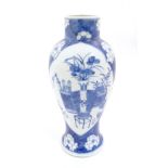 A Chinese blue and white baluster vase decorated with prunus flowers,