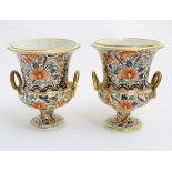 A pair of Royal Crown Derby campana (Campagna) shaped vases raised on a circular foot,