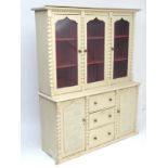 A Victorian painted dresser with a moulded cornice above a glazed top containing shelves,