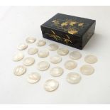 An Oriental lacquered box opening to reveal approx 20 mother of pearl gaming counters.