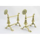 Andirons: a pair of late 19thC cast brass firedogs / tool rests each having a sunflower supported