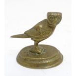 A circa 1900 cast brass Persian style figure of an owl, probably a desk paperweight,