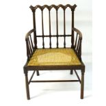 A 19thC mahogany open armchair with a repeating carved cresting rail and scrolled ears,