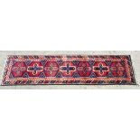 Carpet / Rug : A hand made woollen runner having 7 hexagonal shapes to centre with red chevrons on