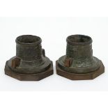 A pair of oriental cast inkwell stands? now with an octagonal wooden base, approx.