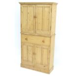 An early 20thC pine cupboard,