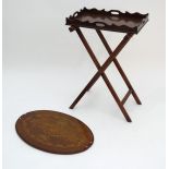 A 19thC mahogany butlers tray with an associated stand and a mahogany Sheraton revival oval table