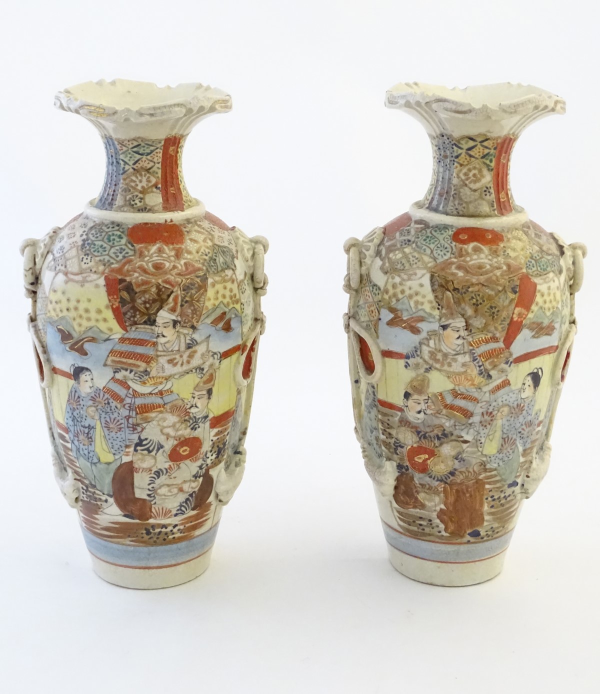 A pair of Japanese Satsuma vases, decorated with figures in a lavish interior,