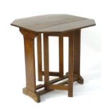 A Cotswold school style oak drop flap table with a chamfered frame and exposed construction.
