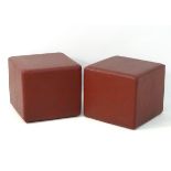 A pair of early 21st ostrich leather footstools of cube form.