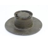 Pewter capstan inkwell: a 19thC circular hinge lidded pewter inkwell for quill or dipping pen use.