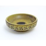 Scandinavian Pottery: A Scandinavian Studio Pottery bowl having brown decoration on a yellow ground.