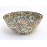 A Cantonese famille rose bowl with panelled decoration depicting figures in traditional dress in