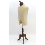 Dressmakers dummy : an adjustable height mannequin on three footed stand ,