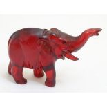 Red Amber: a carved Indian elephant with trunk up,