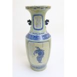 A large blue and white baluster vase with a celadon-like ground and twin handles.