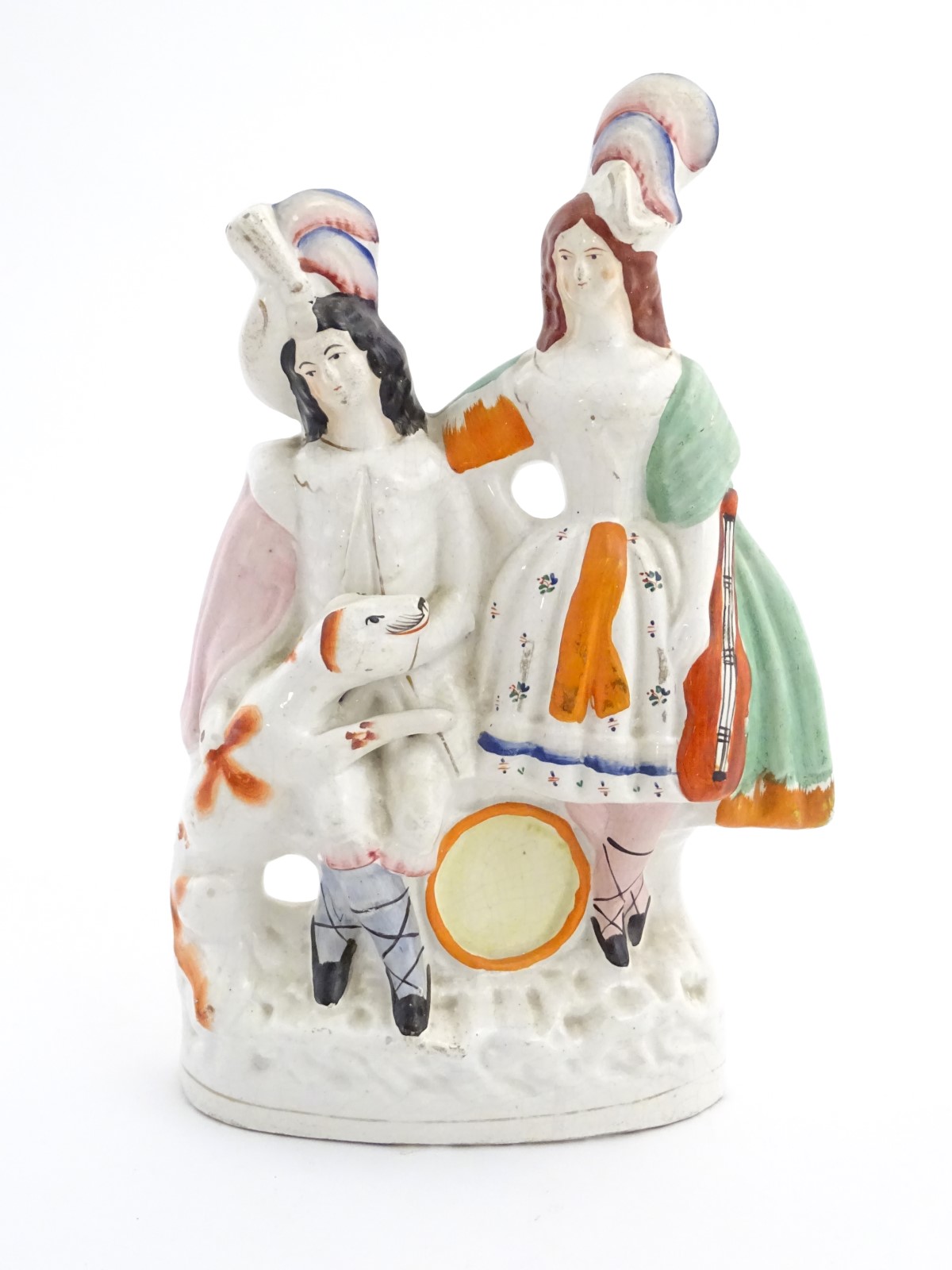 A Staffordshire pottery figural group of two figures with instruments in formal wear and plumed