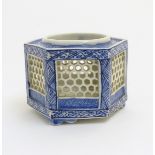 A Chinese blue and white reticulated pot of hexagonal form, decorated with geometric patterns,