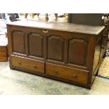 An 18thC oak coffer / mule chest of peg jointed construction, with panelled front and sides,