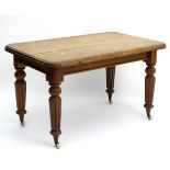 A Victorian mahogany table with a rectangular moulded top above reeded tapering legs terminating in