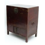 A 19thC Oriental tall coffer, of elm construction with hinged top and diminutive doors under,