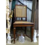 A pair of early 20thC mahogany chairs with caned backrest and seat,