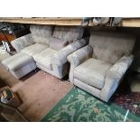 A two seater sofa upholstered in beige with grey floral highlights,